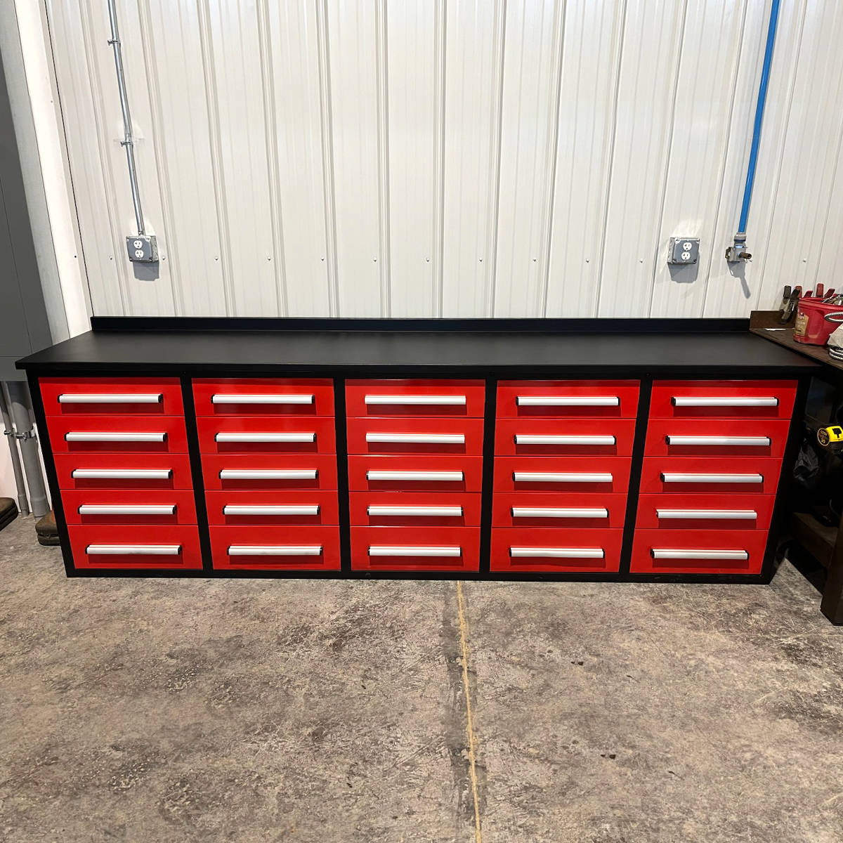 Red tool cabinet with multiple drawers in a garage setting#color_red
