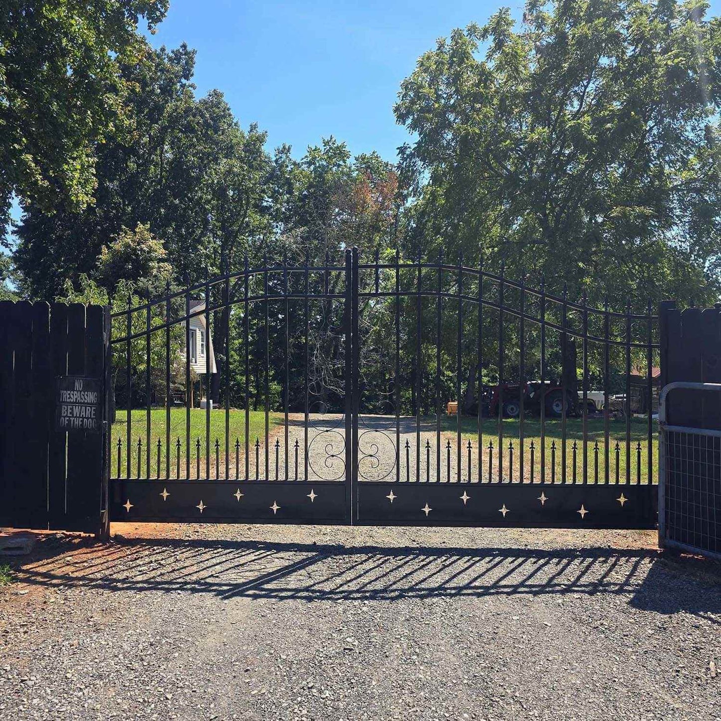 20ft dual swing driveway gate with star pattern applied in a residential property