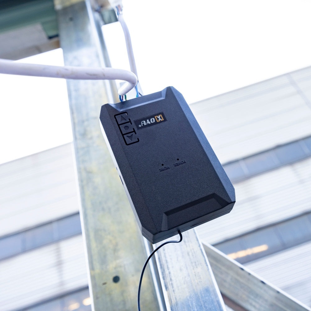 Black electronic device attached to a metal structure with a blurred background#Operation Type_Electric 110V Motor