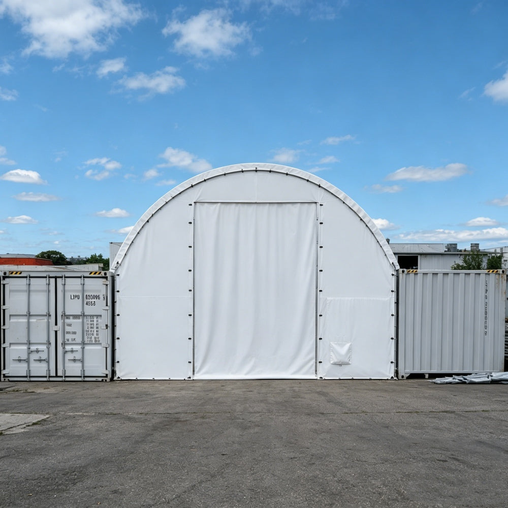White portable storage shed with a door in an outdoor setting