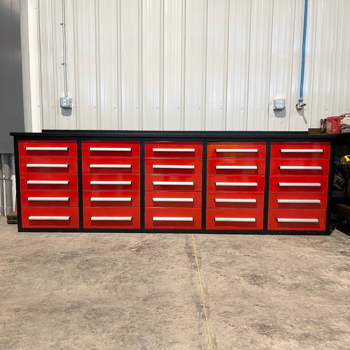 Red tool cabinet with multiple drawers in a workshop setting