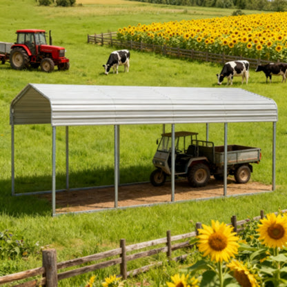 Metal carport in a rural setting with a tractor, cows, and sunflowers.