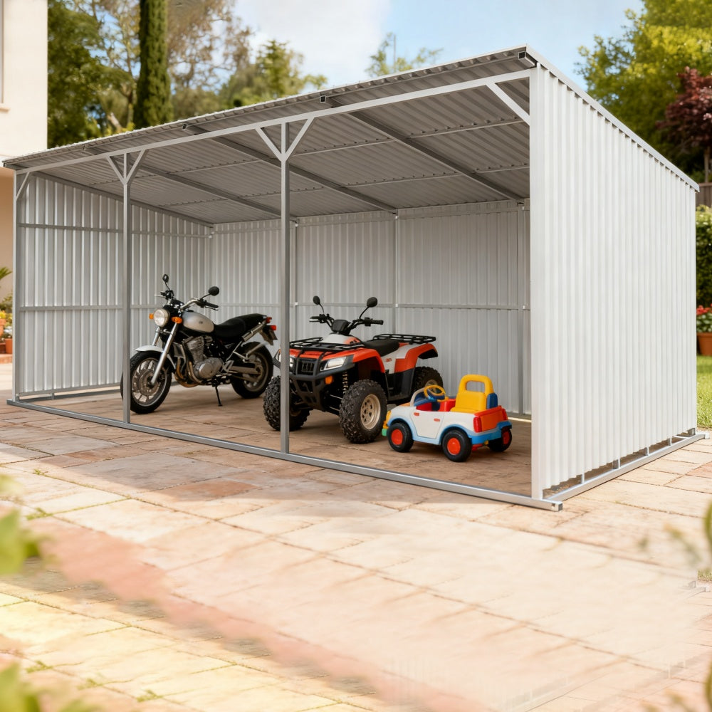 Metal carport with a motorcycle, ATV, and toy car inside on a sunny day.