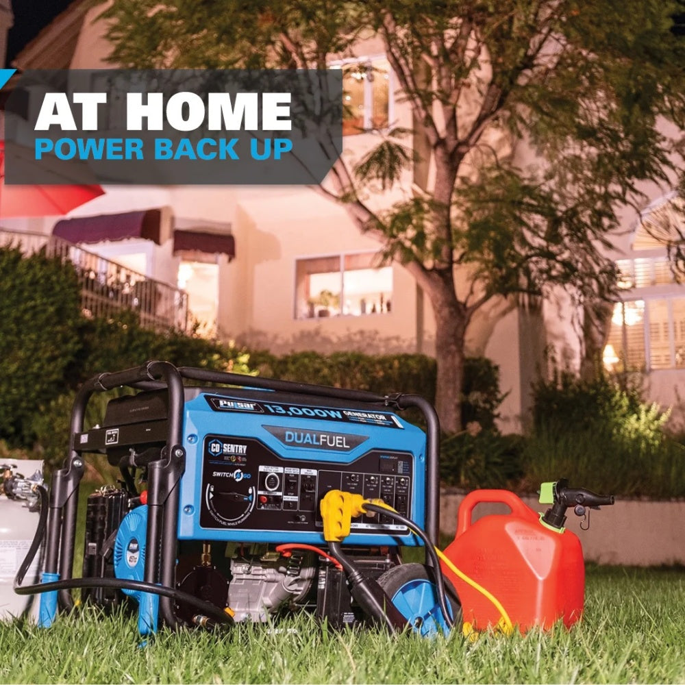 A blue and black dual-fuel portable generator sits on grass in front of a house at night