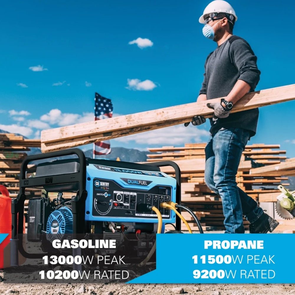A man in a construction setting carries a wood beam beside a portable generator.