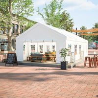 White tent with outdoor furniture on a brick pavement