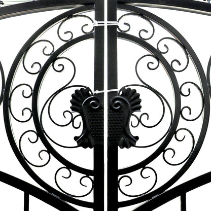 Black wrought iron gate with ornate scrollwork and decorative finials