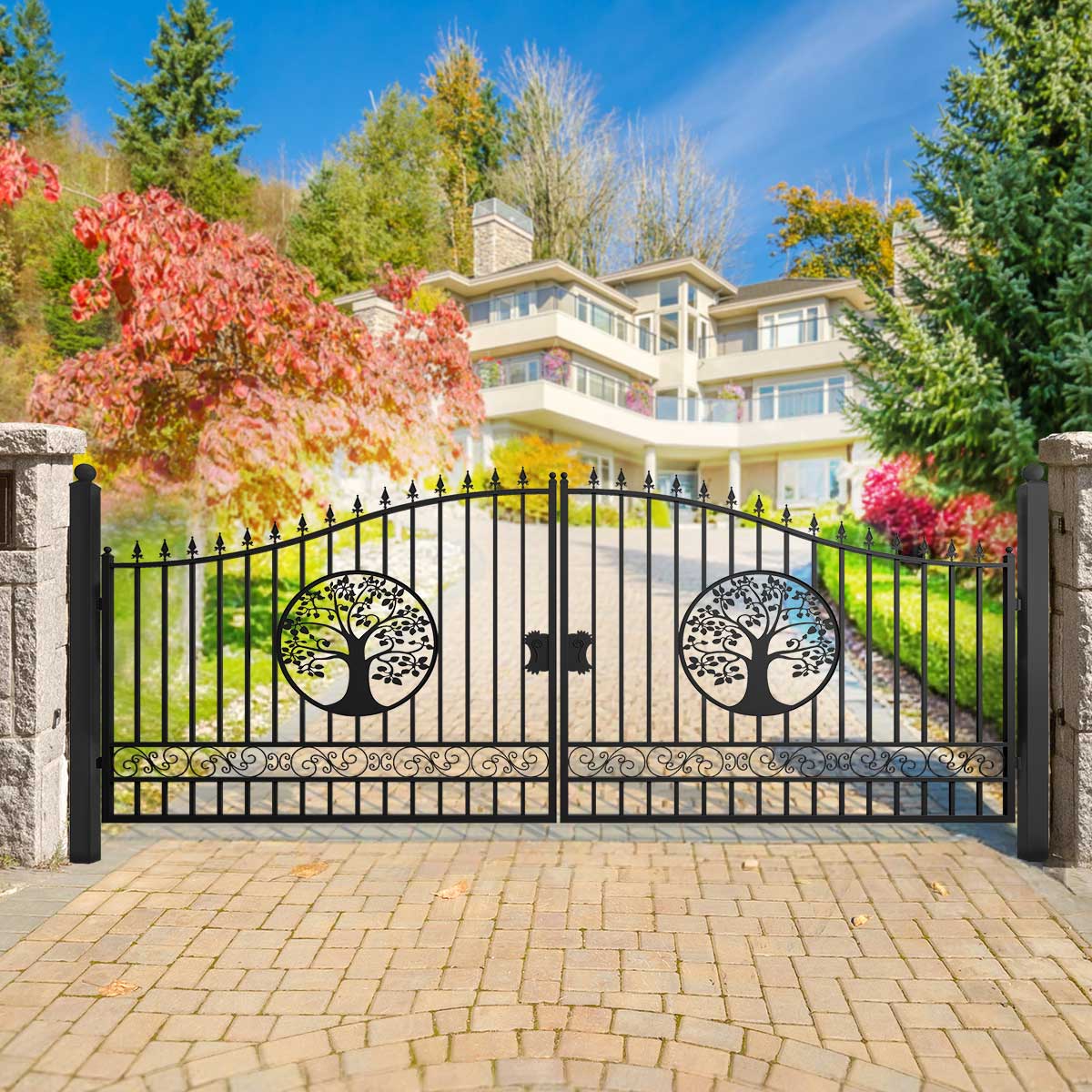 Wrought iron gate with tree designs in front of a large house with a garden.