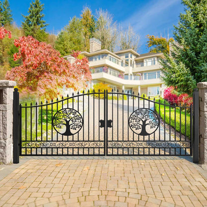 Wrought iron gate with tree designs in front of a large house with a garden.