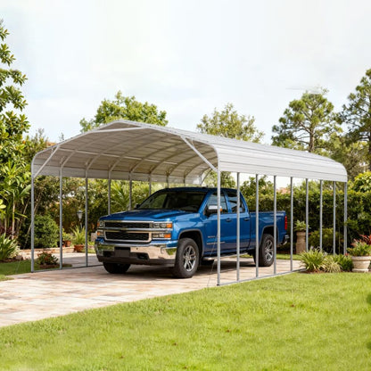 Blue truck parked under a metal carport with trees and greenery in the background