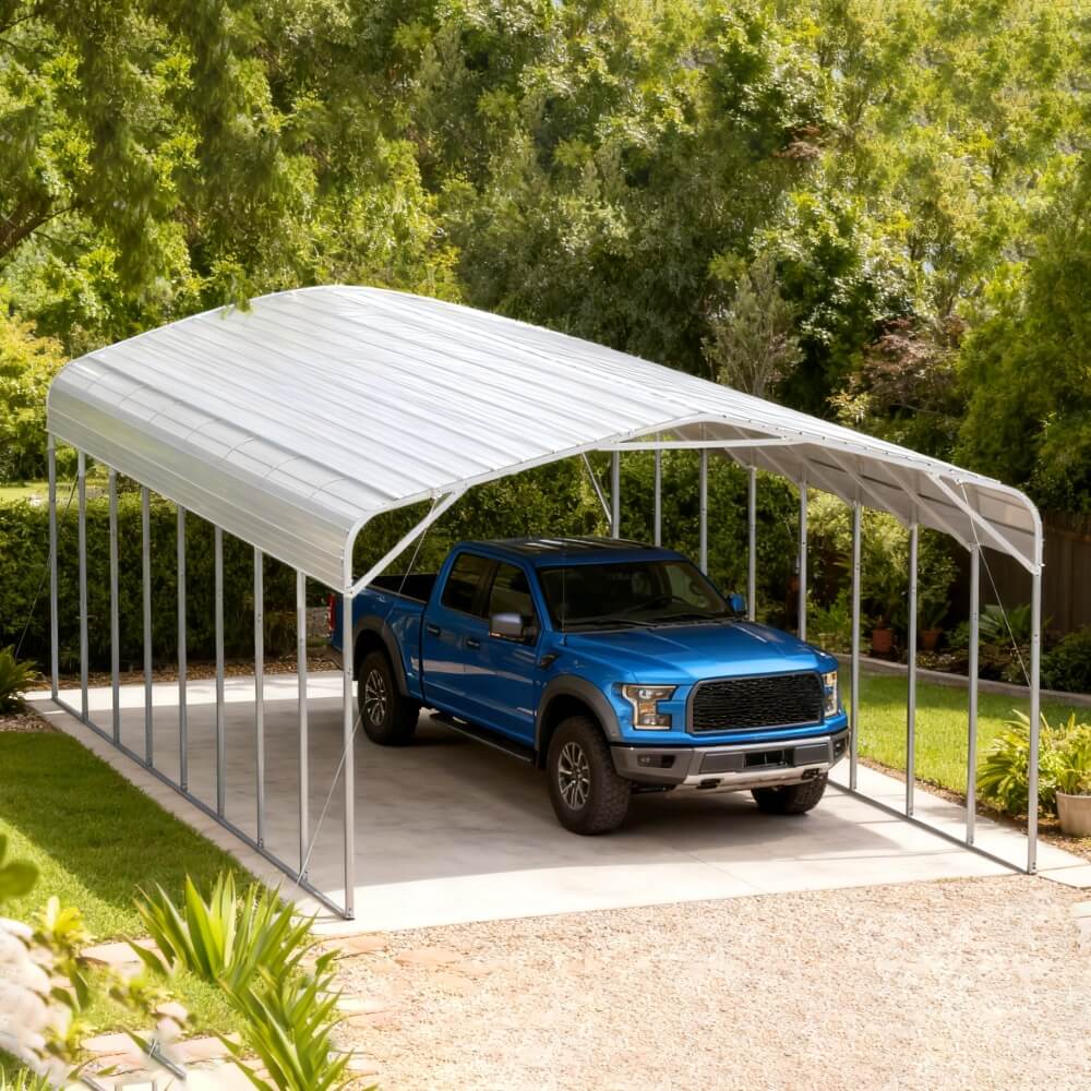 Blue truck parked under a metal carport with trees in the background