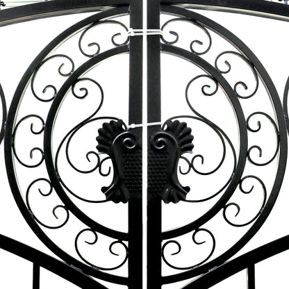 Black wrought iron gate with ornate scrollwork and decorative finials