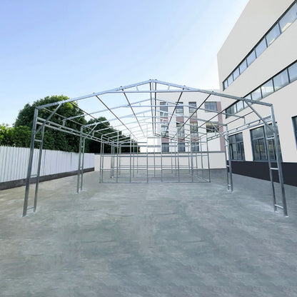 Metal frame structure on a concrete surface with a building in the background#color_White