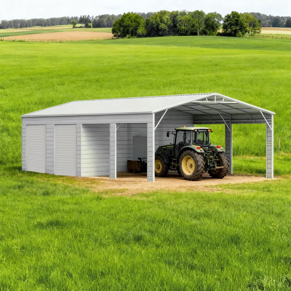 Metal storage building with a tractor inside, set against a green field.