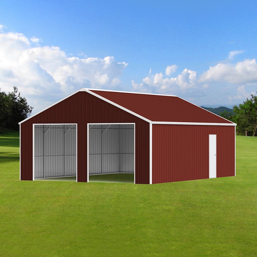 Red metal garage with white doors on a grassy field under a blue sky.