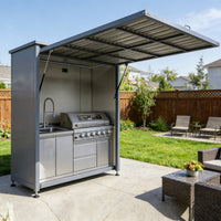 Outdoor kitchen with grill and sink in a backyard setting