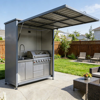 Outdoor kitchen with grill and sink in a backyard setting