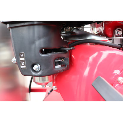 Close-up of a red motorcycle with a black exhaust pipe and control lever.