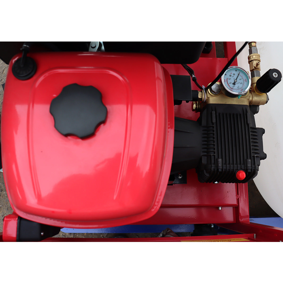 Red pressure washer with visible pump and gauge on a white background