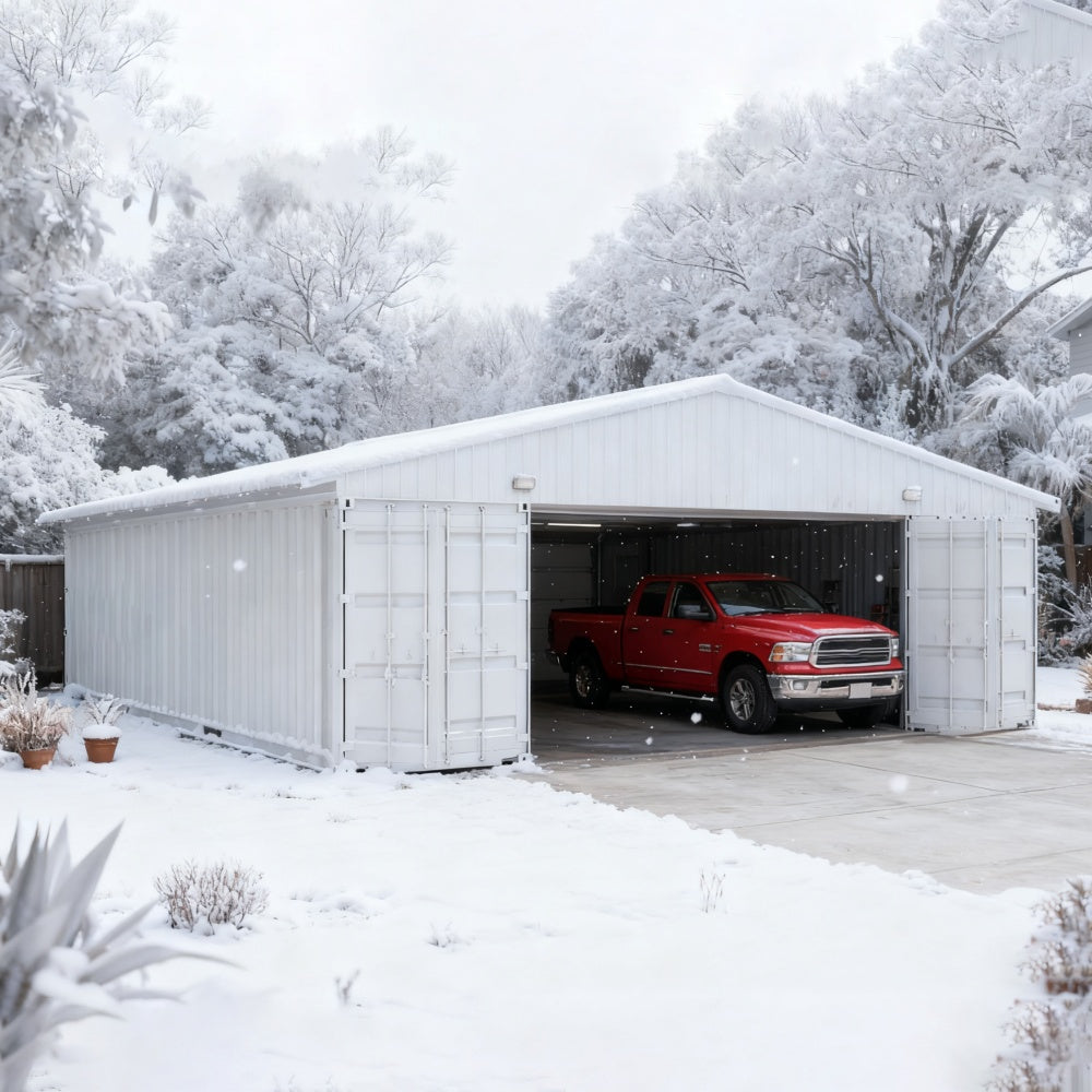 White metal garage with a red truck inside, surrounded by snow and trees.#color_White