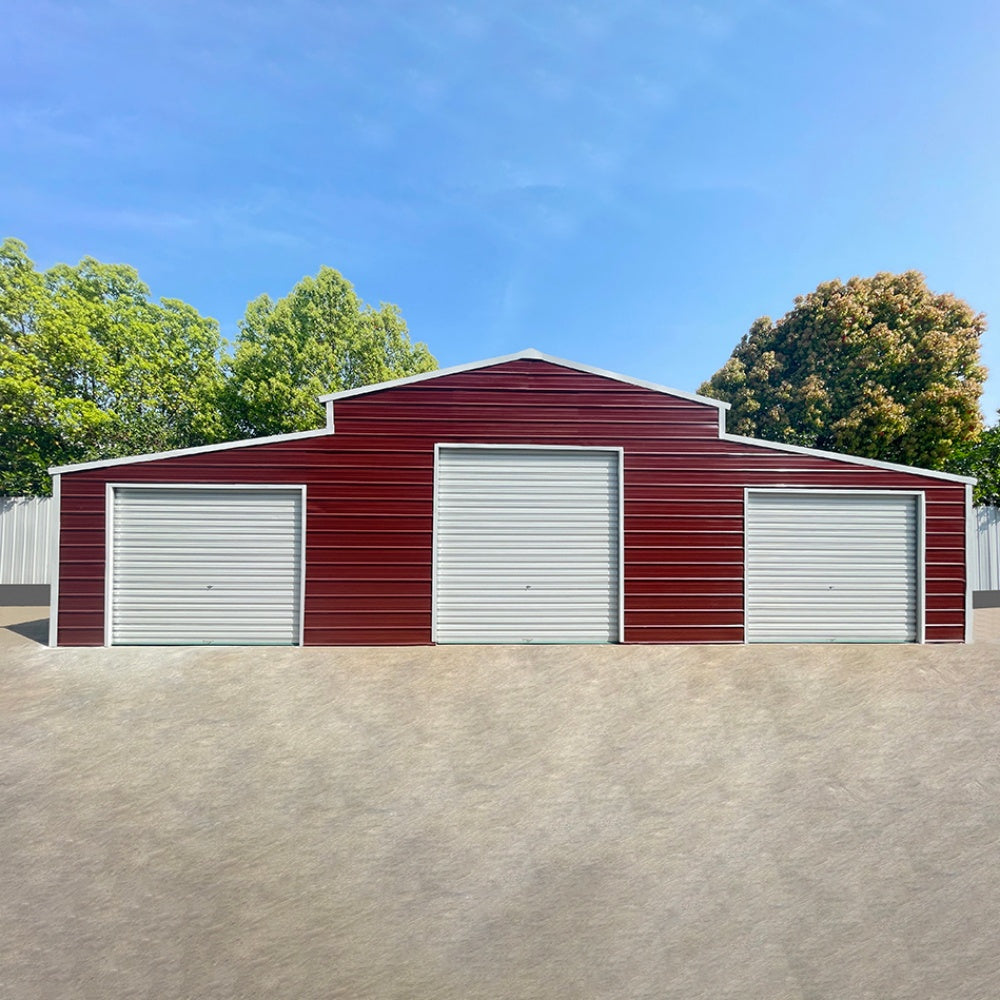 Red metal garage with white doors on a clear day