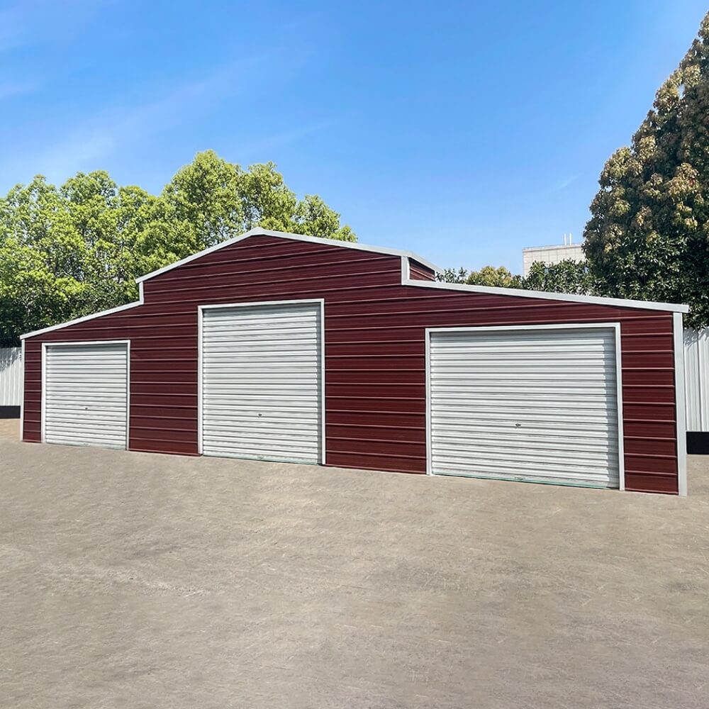 Red metal garage with three white doors on a clear day