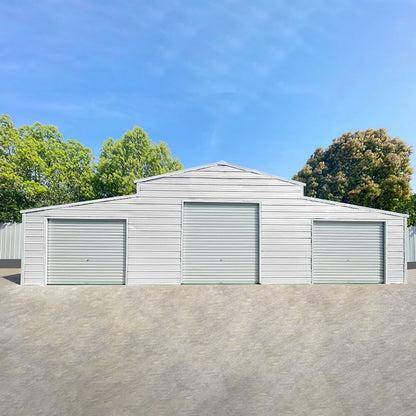 White storage shed with three garage doors against a blue sky#color_White