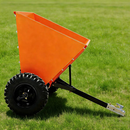 Orange dump cart on a grassy field