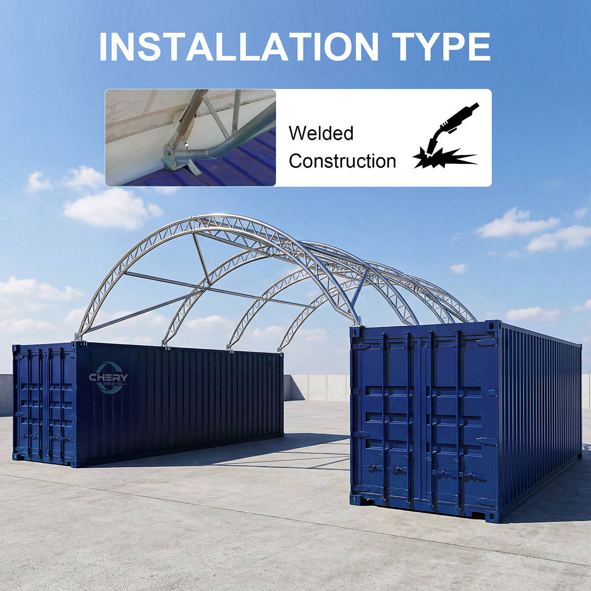 Two blue shipping containers with a metal arch structure against a blue sky.
