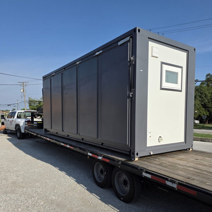 Mobile house shipped folded on flatbed trailer