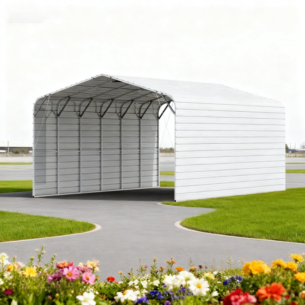 Metal carport with white walls and black roof on a grassy area with flowers.