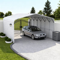 Carport with a car parked inside, surrounded by greenery and a white fence.