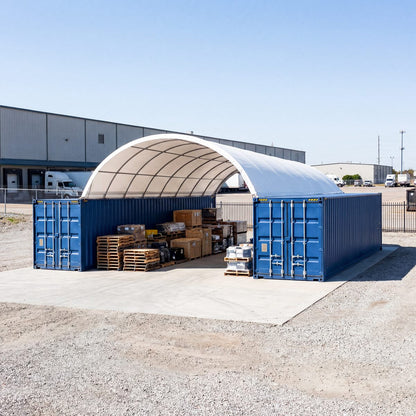 container shelter with blue containers and pallets in front of a building.