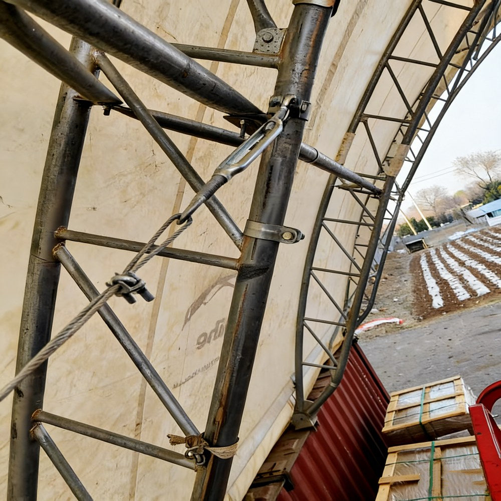 Metal scaffolding structure with a container and boxes in the background