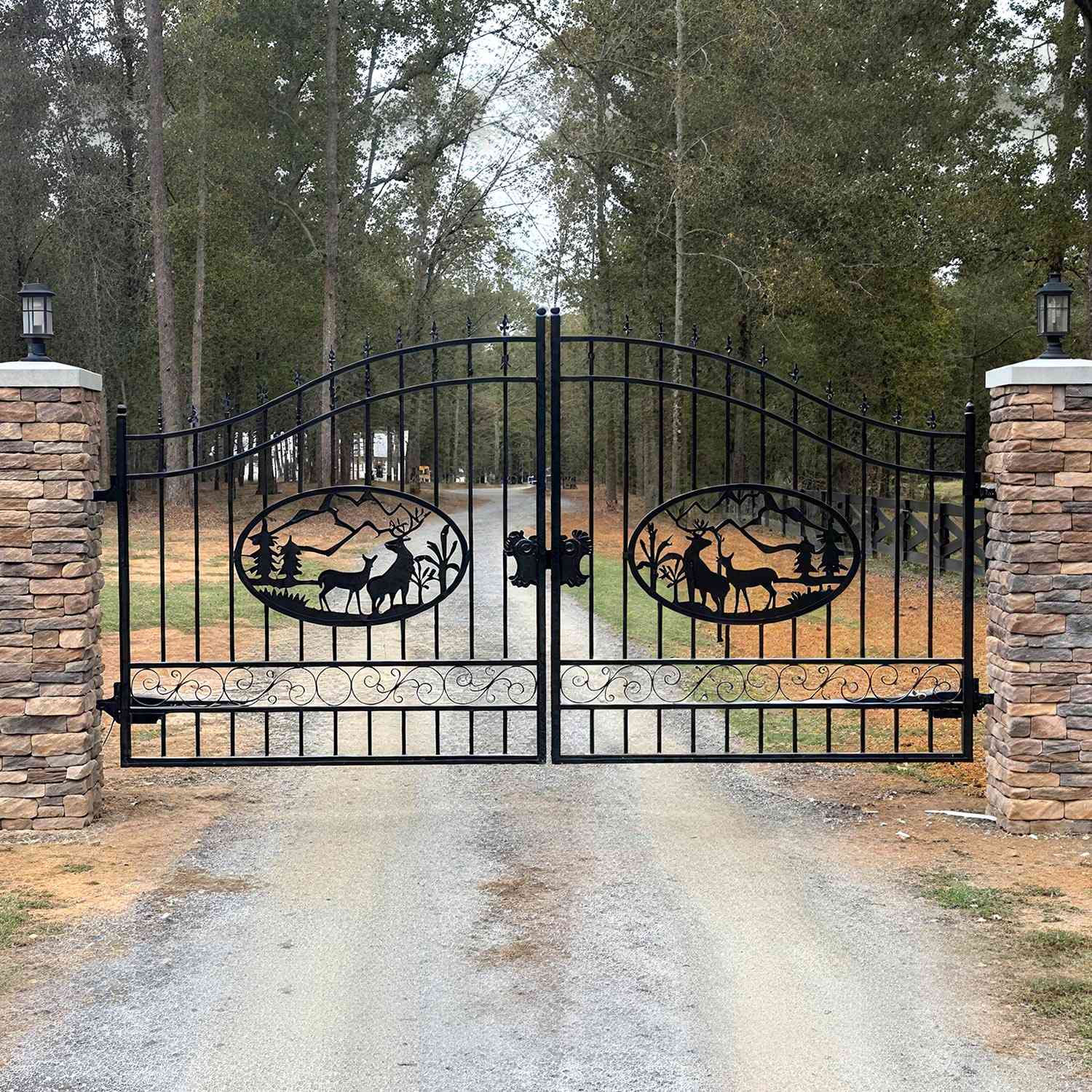 The deer pattern driveway gate is used in a forest.