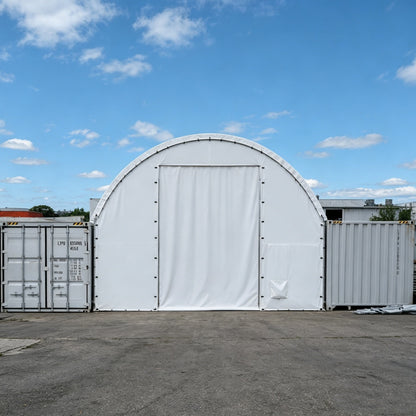 White portable storage shed with a door in an outdoor setting