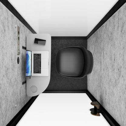 Small office space with a desk, laptop, and chair.