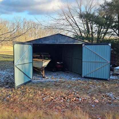 metal shed with boats and vehicle