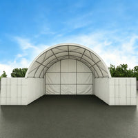 Arch-shaped storage building with white walls and a blue sky background