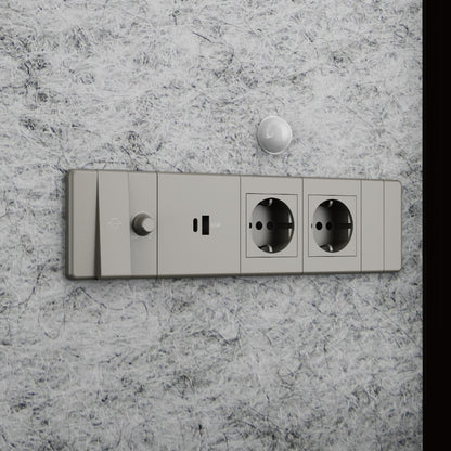 Wall-mounted electrical socket with two sockets and a switch on a marble wall.