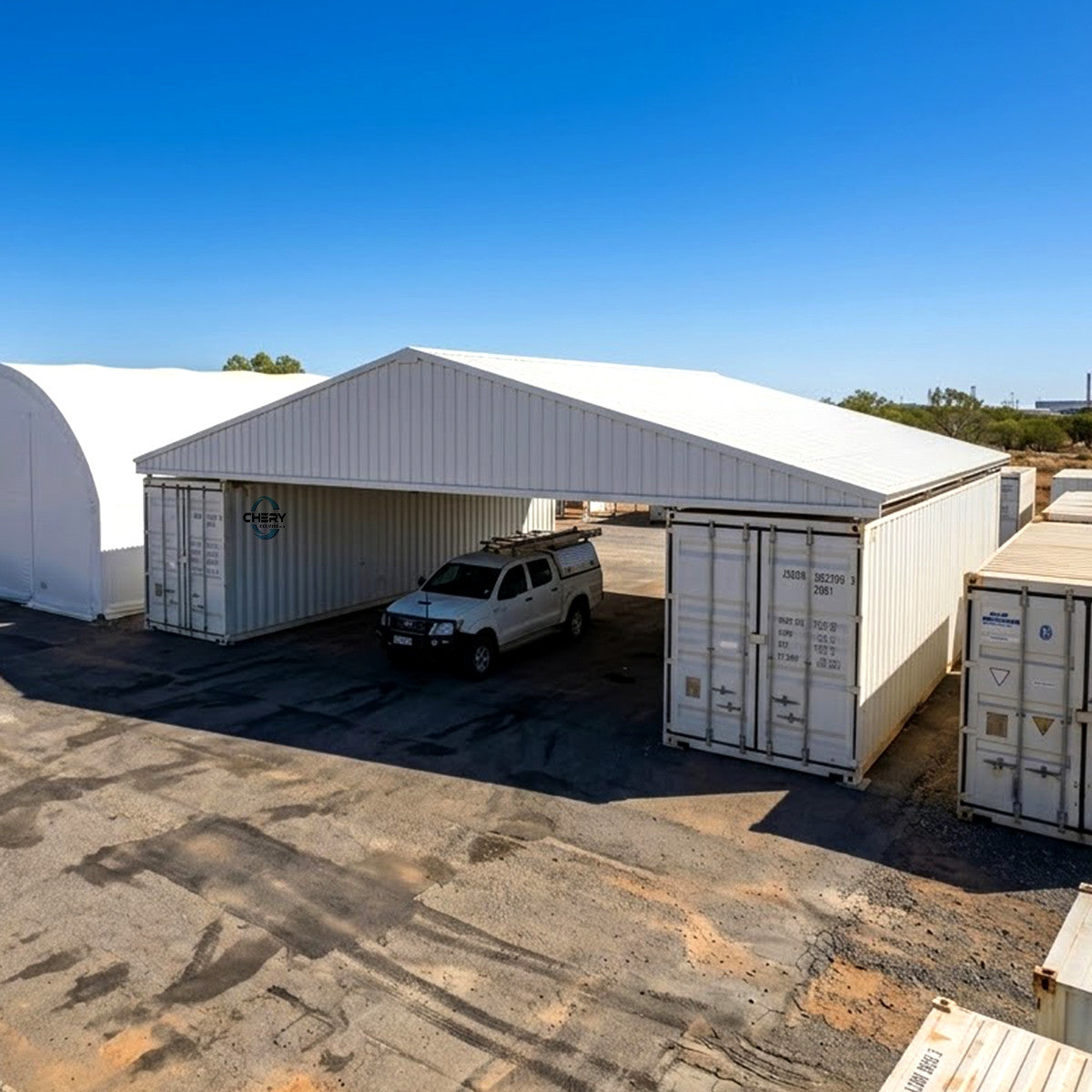 A white pickup truck is parked inside the W40'xL40'xH6' Steel Shipping Container Roof Kit