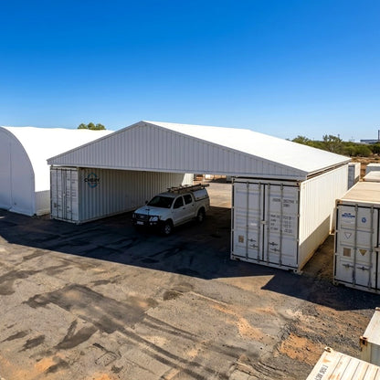 A white pickup truck is parked inside the W40'xL40'xH6' Steel Shipping Container Roof Kit