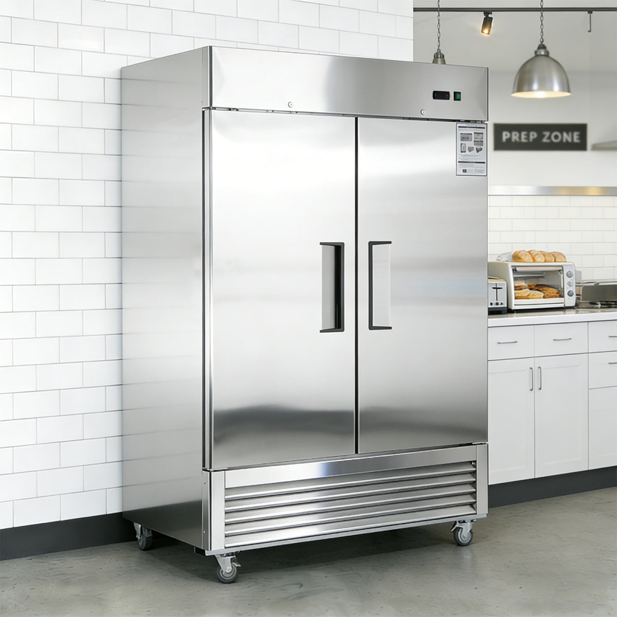 Stainless steel refrigerator in a kitchen setting with white tiled walls and cabinets.