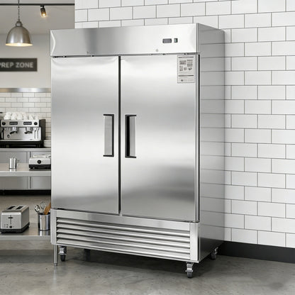 Stainless steel refrigerator in a kitchen setting with tiled walls.