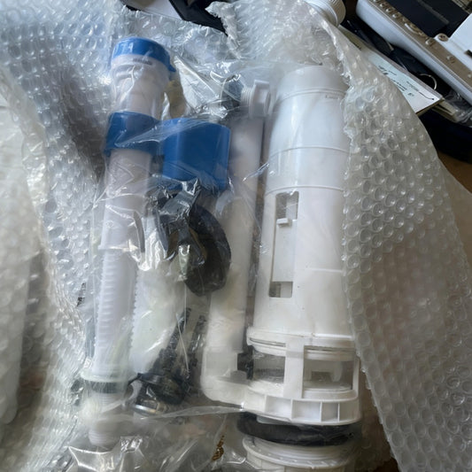 Plumbing parts in packaging on a bubble-wrapped surface